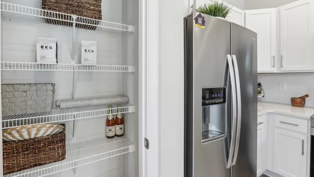 a kitchen with stainless steel appliances a refrigerator and cabinets