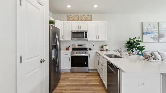 a kitchen with a sink stove and refrigerator
