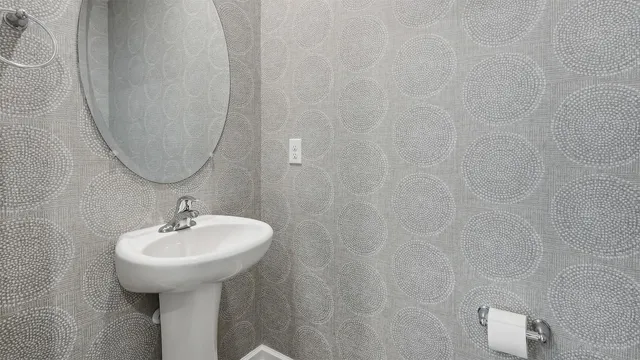 a bathroom with a sink a mirror and vanity