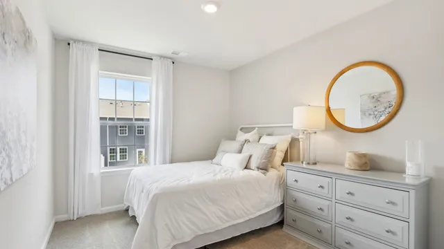 a bedroom with bed and a mirror