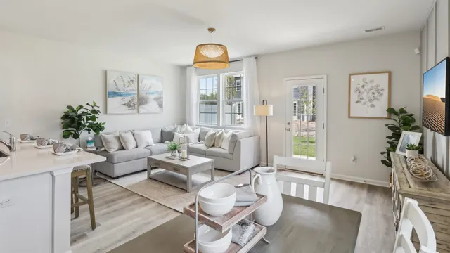 a living room with furniture a dining table and a large window