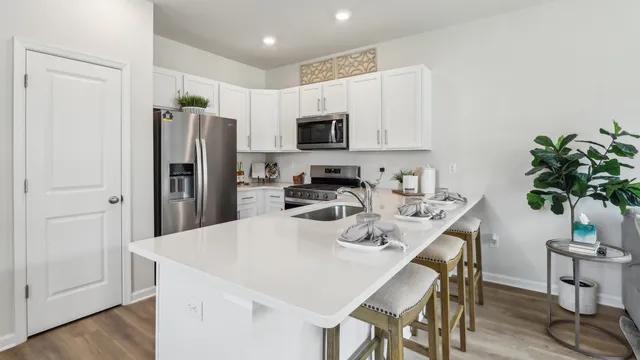 a kitchen with stainless steel appliances a refrigerator and a stove