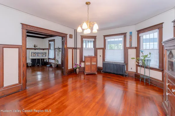 a view of a livingroom with furniture window and wooden floor
