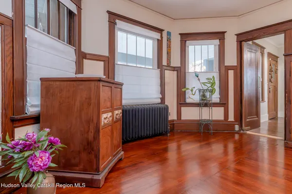 a view of a dining room with furniture and wooden floor