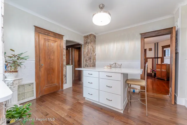 a room that has a mirror and a wooden floor