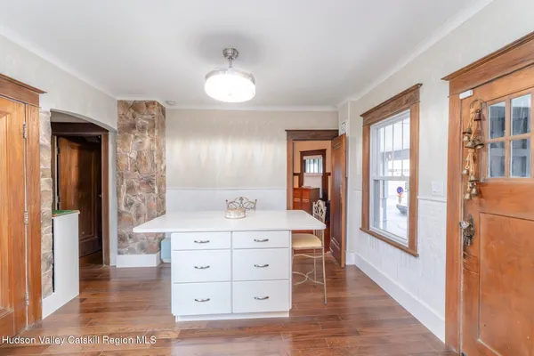 a view of staircase with wooden floor and a rug