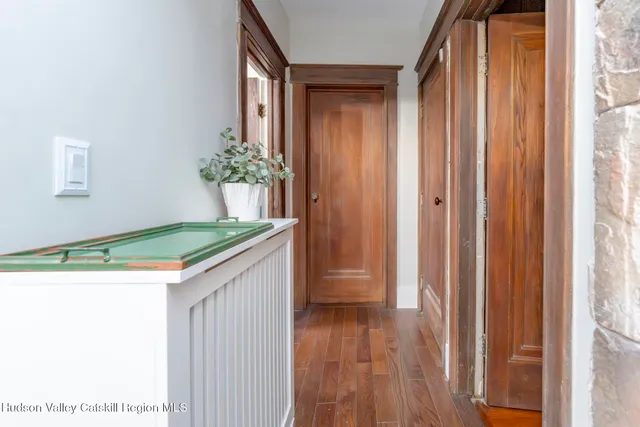 a view of entryway and hall with wooden floor