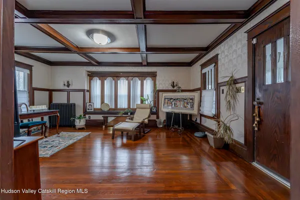 a living room with fireplace furniture and a wooden floor