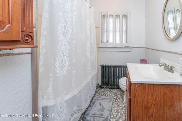 a view of a livingroom with wooden floor and a ceiling fan