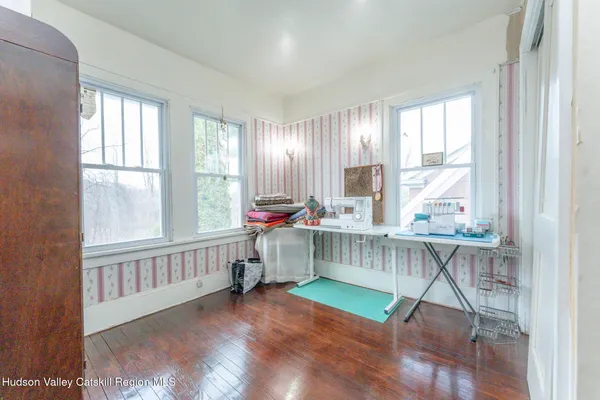 an empty room with a fireplace and painted walls
