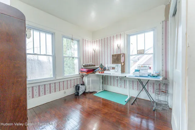 an empty room with a fireplace and painted walls