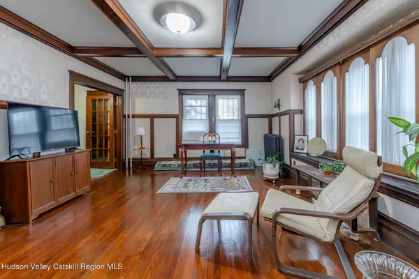 a living room with furniture flat screen tv and wooden floor