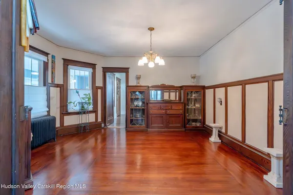 a view of an livingroom with furniture hardwood floor and a chandelier