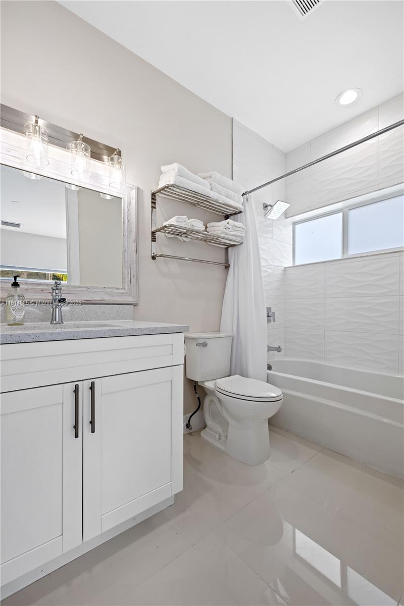 12 Adams Road Ocean Ridge, FL 33435 - Photo 11 of 24 a bathroom with a sink a toilet and shower