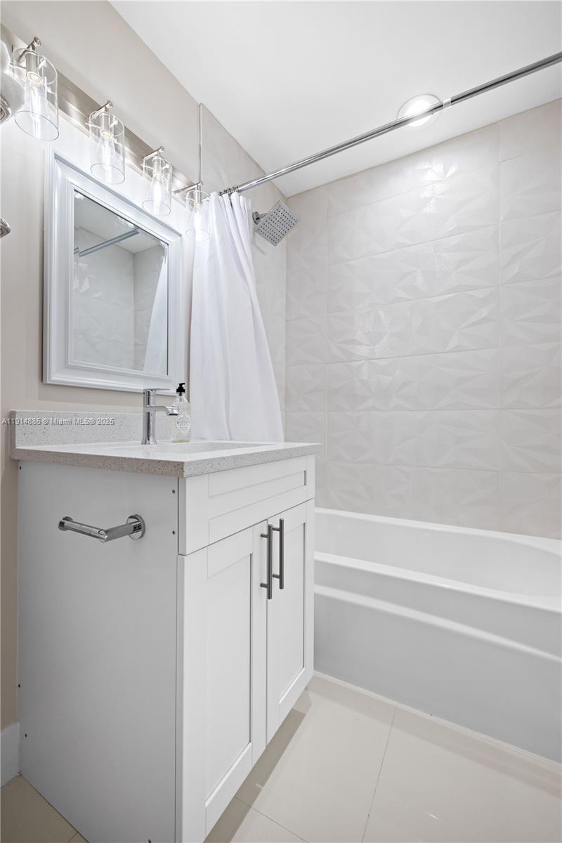 12 Adams Road Ocean Ridge, FL 33435 - Photo 14 of 24 a bathroom with a sink a mirror and a shower