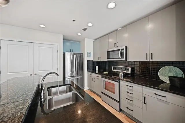 a view of a kitchen with appliances and cabinets