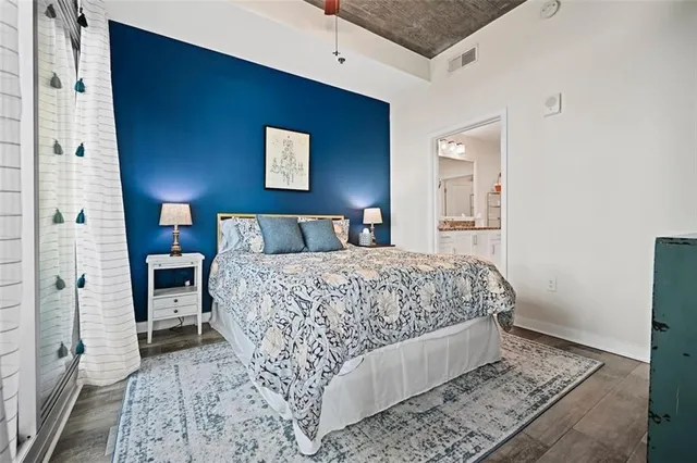 a bedroom with a bed and a large window