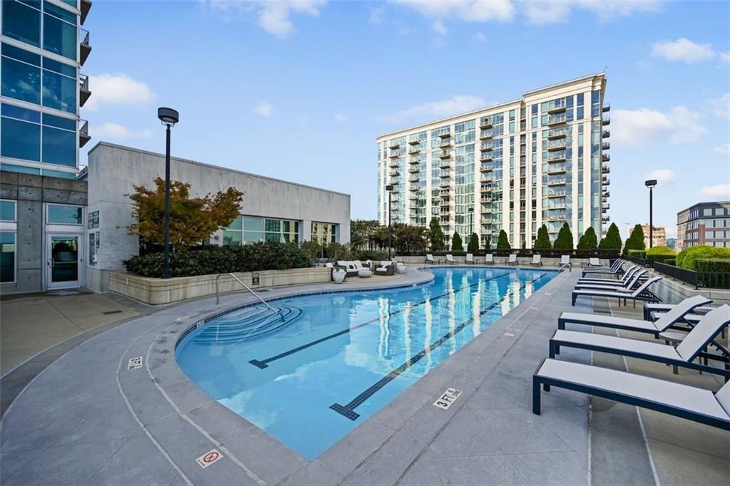 250 Pharr Road Northeast, Unit 602 Atlanta, GA 30305 - Photo 22 of 38 a view of swimming pool with outdoor seating and plants