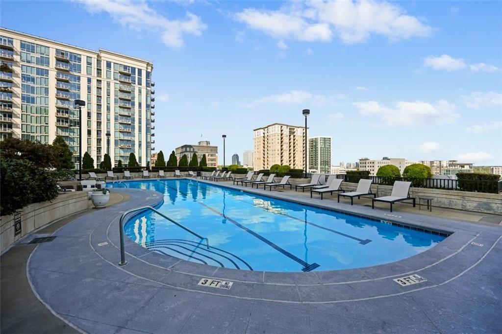 250 Pharr Road Northeast, Unit 602 Atlanta, GA 30305 - Photo 23 of 38 a view of a swimming pool with outdoor seating