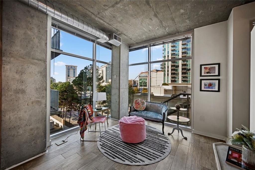250 Pharr Road Northeast, Unit 602 Atlanta, GA 30305 - Photo 3 of 38 a living room with furniture and a potted plant
