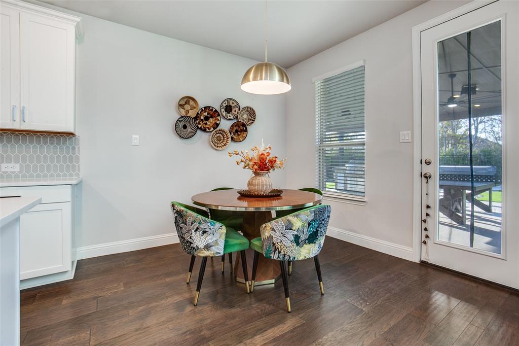 311 Suncrest Way Sunnyvale, TX 75182 - Photo 19 of 40 a dining room with furniture a chandelier and wooden floor