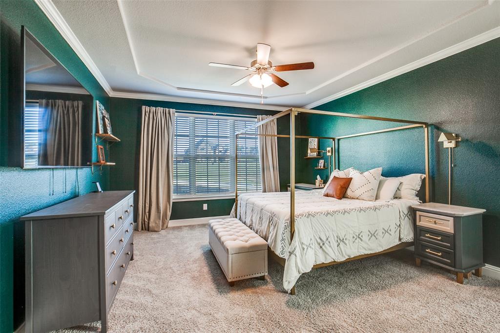 311 Suncrest Way Sunnyvale, TX 75182 - Photo 20 of 40 a spacious bedroom with a bed and a chandelier