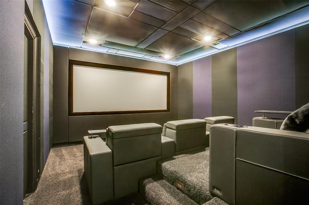311 Suncrest Way Sunnyvale, TX 75182 - Photo 25 of 40 a media room with lots of chairs and a projector screen