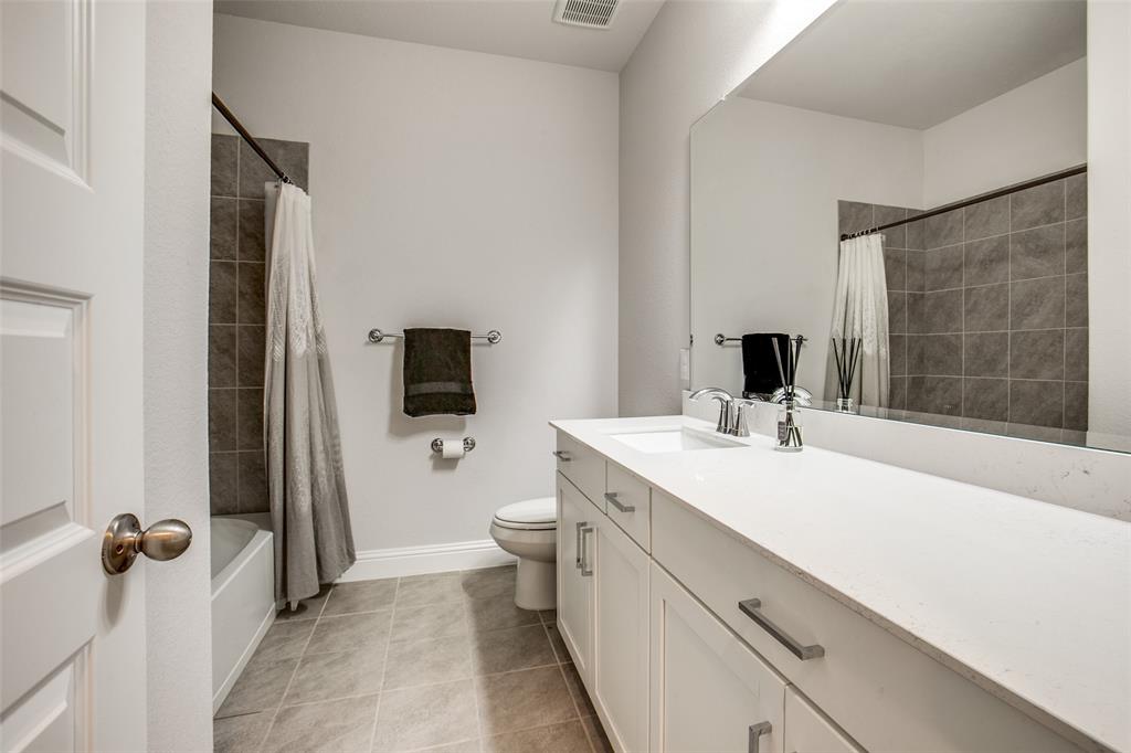 311 Suncrest Way Sunnyvale, TX 75182 - Photo 26 of 40 a bathroom with a sink a toilet and mirror