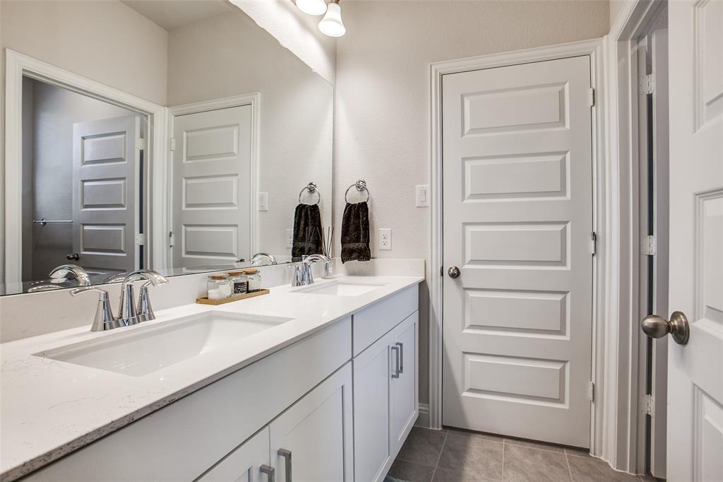 311 Suncrest Way Sunnyvale, TX 75182 - Photo 30 of 40 a bathroom with a double vanity sink and mirror