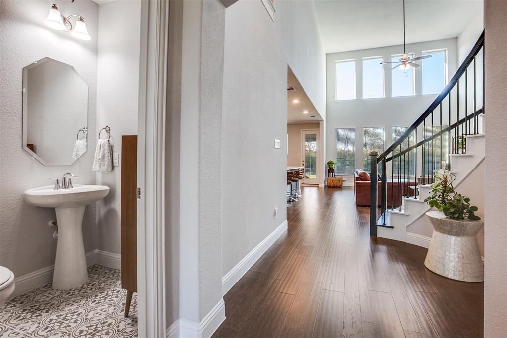 311 Suncrest Way Sunnyvale, TX 75182 - Photo 8 of 40 a hallway with wooden floor a sink and a potted plant