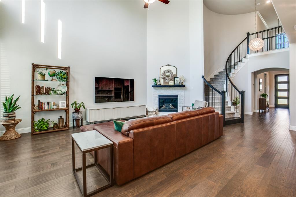 311 Suncrest Way Sunnyvale, TX 75182 - Photo 10 of 40 a living room with furniture a fireplace and a flat screen tv