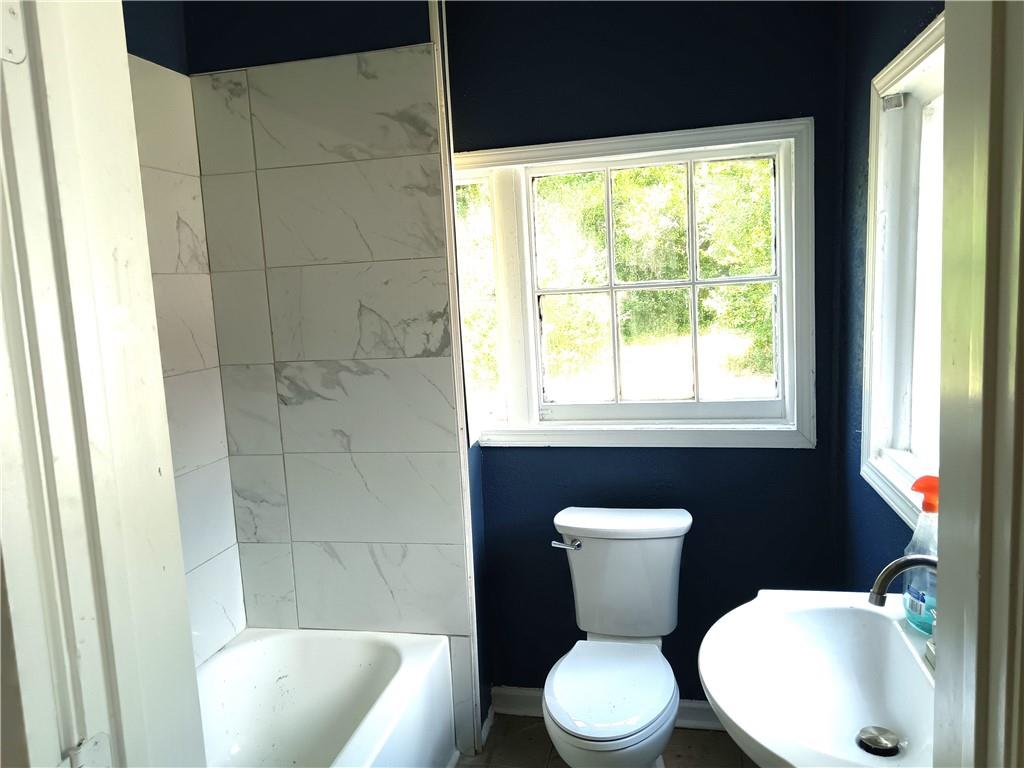 3435 Hillcrest Road Macon, GA 31204 - Photo 9 of 12 a bathroom with a toilet sink and mirror