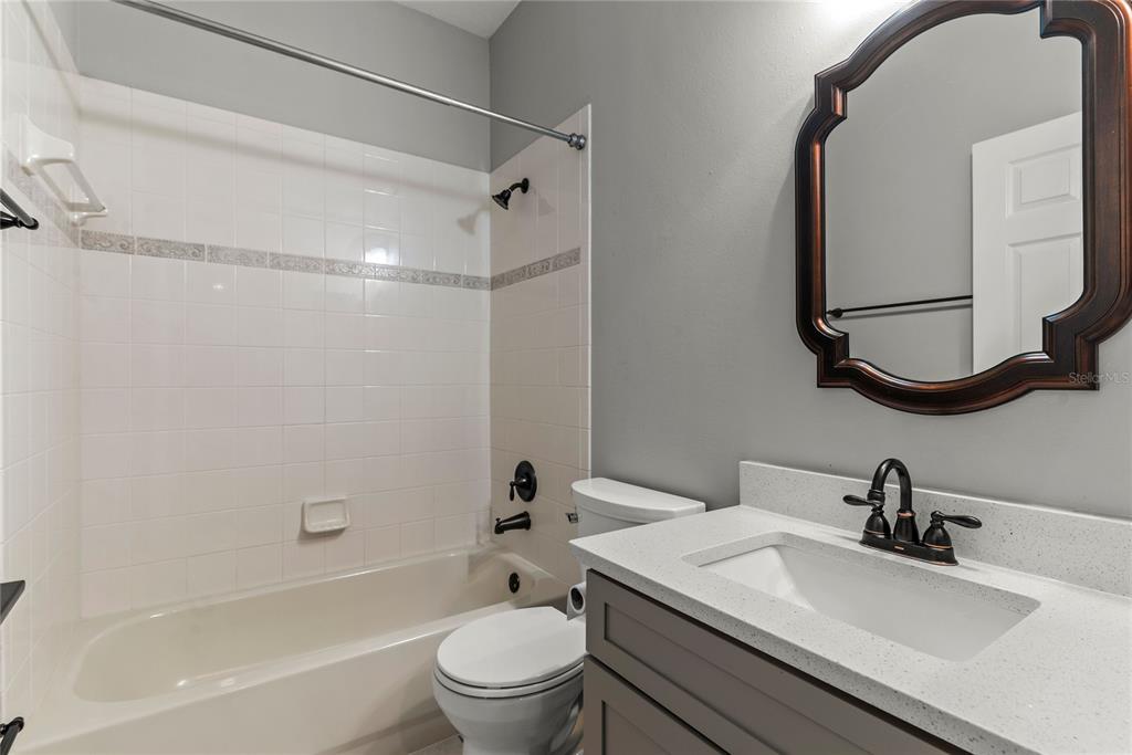 121 Figtree Run Longwood, FL 32750 - Photo 16 of 33 a bathroom with a granite countertop sink toilet and shower