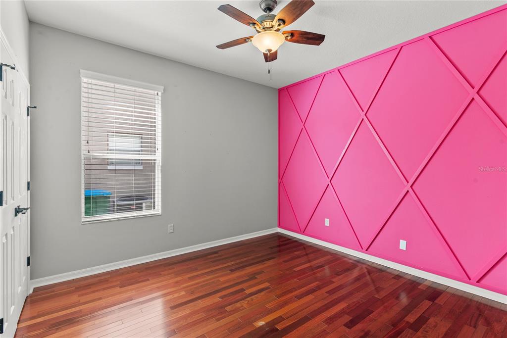 121 Figtree Run Longwood, FL 32750 - Photo 17 of 33 a view of an empty room with wooden floor and a window