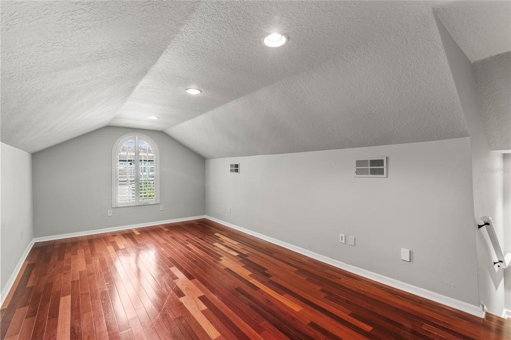 121 Figtree Run Longwood, FL 32750 - Photo 18 of 33 an empty room with wooden floor and windows
