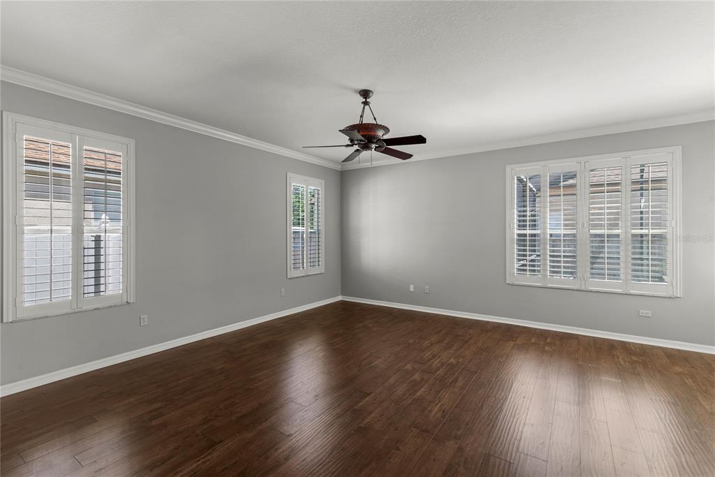 121 Figtree Run Longwood, FL 32750 - Photo 20 of 33 a view of an empty room with wooden floor and a window