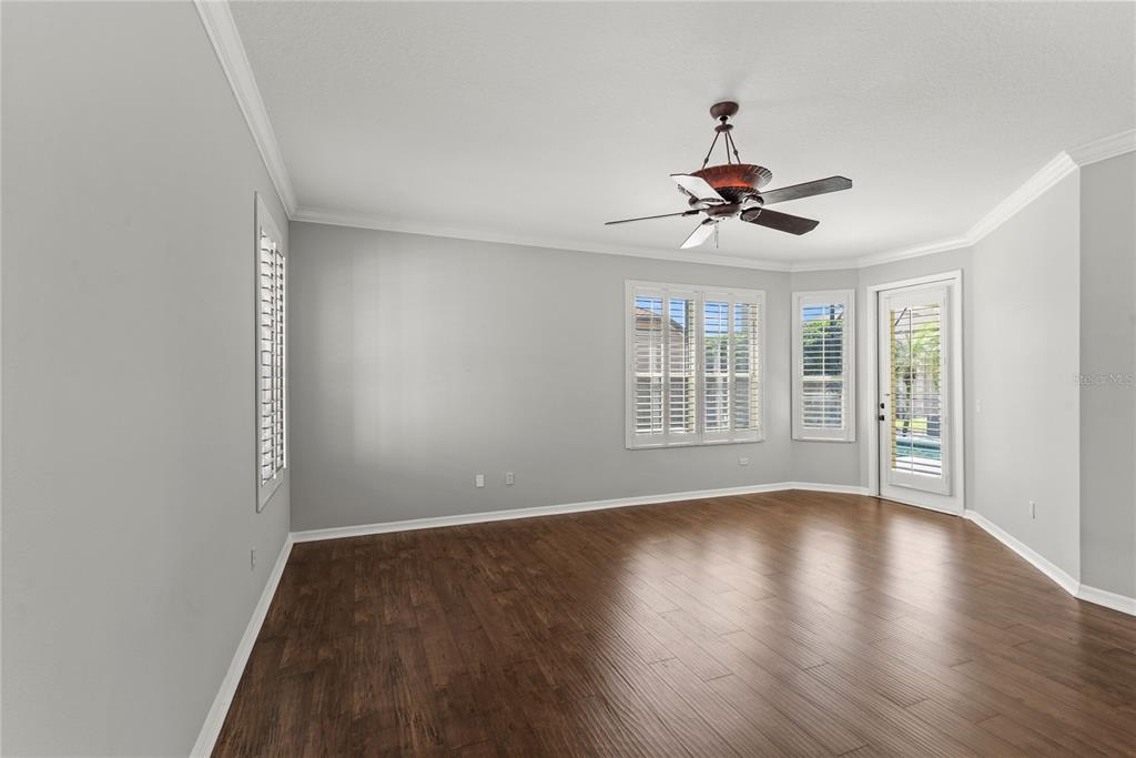 121 Figtree Run Longwood, FL 32750 - Photo 22 of 33 a view of an empty room with wooden floor and a window