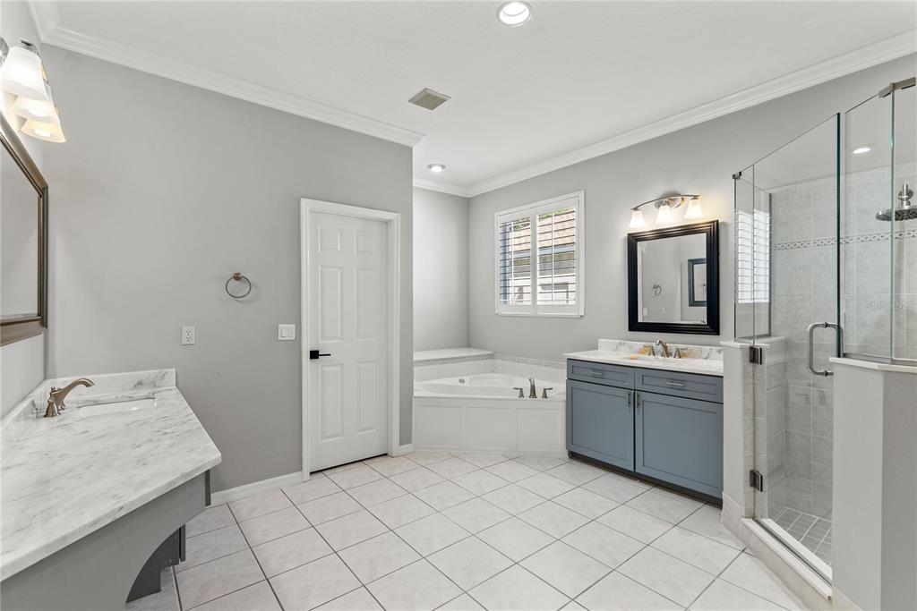 121 Figtree Run Longwood, FL 32750 - Photo 23 of 33 a bathroom with a granite countertop sink mirror and bathtub