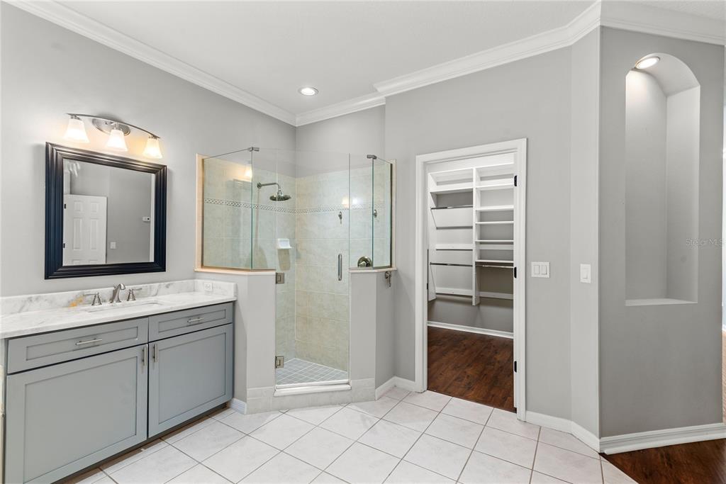 121 Figtree Run Longwood, FL 32750 - Photo 24 of 33 a spacious bathroom with a shower a sink and a mirror