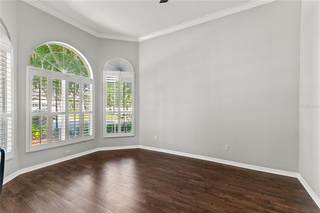121 Figtree Run Longwood, FL 32750 - Photo 27 of 33 a view of an empty room with wooden floor and a window