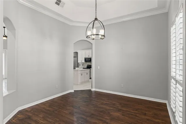 a view of a room with wooden floor closet and a window