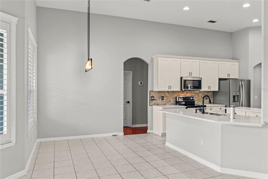 121 Figtree Run Longwood, FL 32750 - Photo 6 of 33 a kitchen with stainless steel appliances a refrigerator sink and microwave