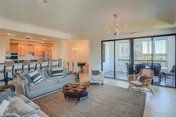 a living room with furniture and a chandelier