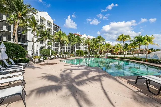 a view of a swimming pool with a table and chairs