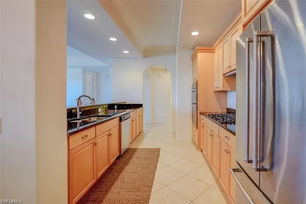 a kitchen with stainless steel appliances granite countertop a stove and a refrigerator