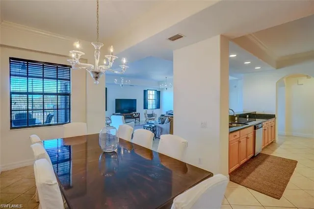 a view of a dining room with furniture a chandelier and wooden floor