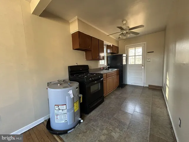 a kitchen with stainless steel appliances a stove top oven a sink and a refrigerator