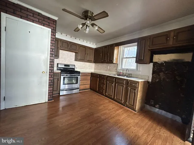 a kitchen with stainless steel appliances granite countertop a stove a sink dishwasher and a refrigerator