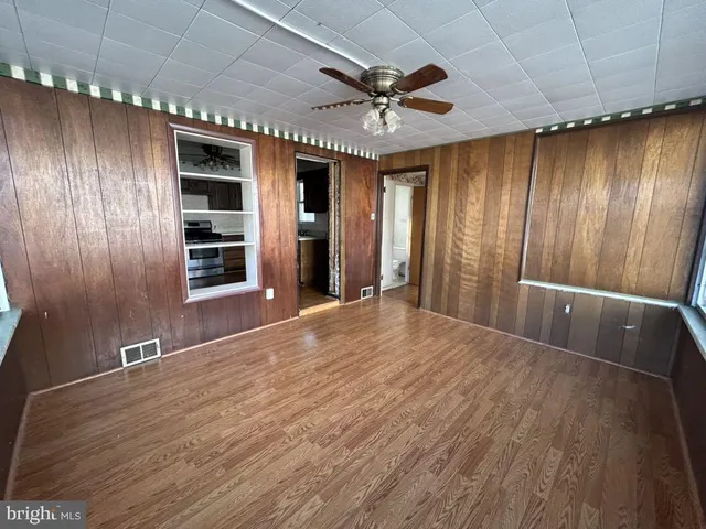wooden floor in an empty room with a window
