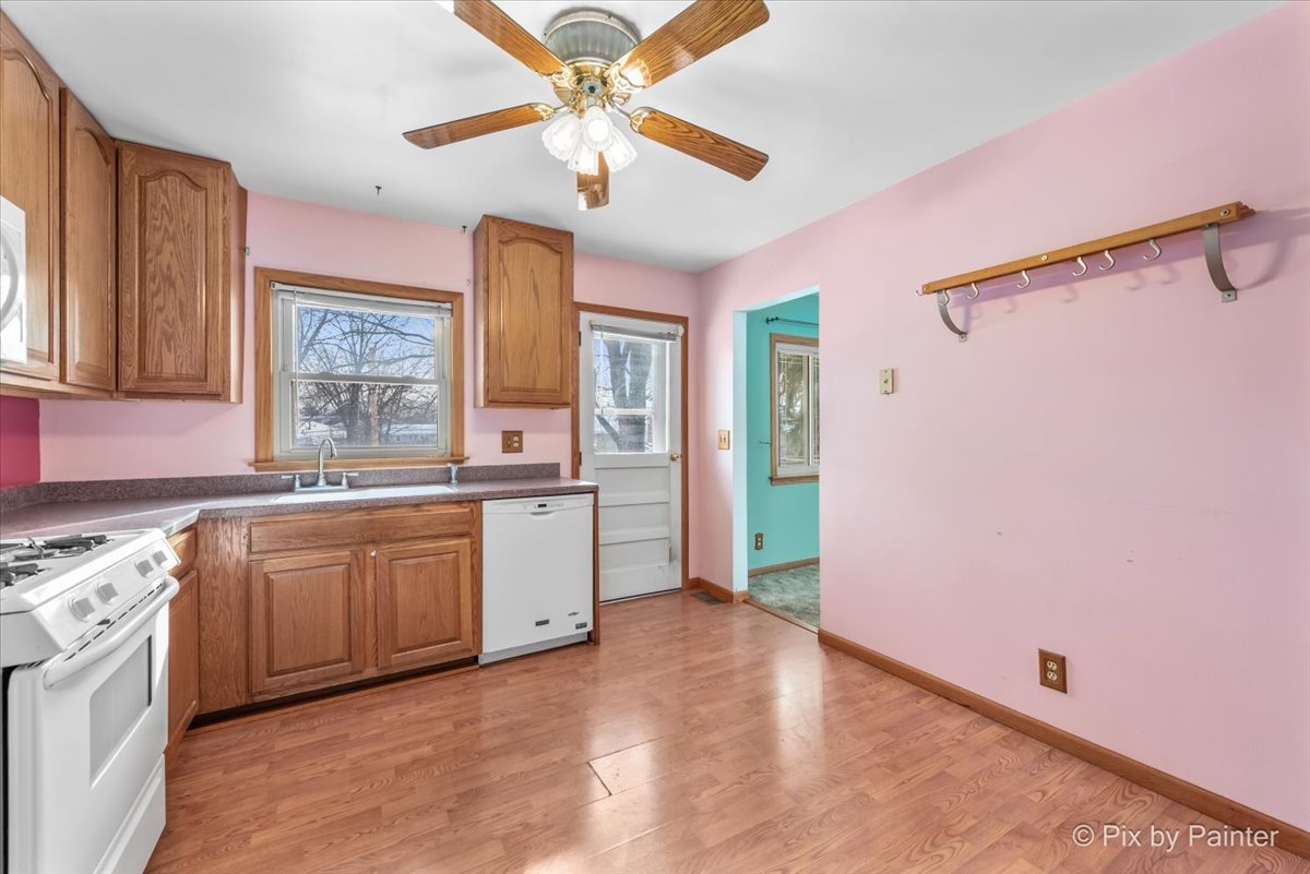 411 Krause Avenue Streamwood, IL 60107 - Photo 11 of 54 a large kitchen with granite countertop a stove a sink and a refrigerator